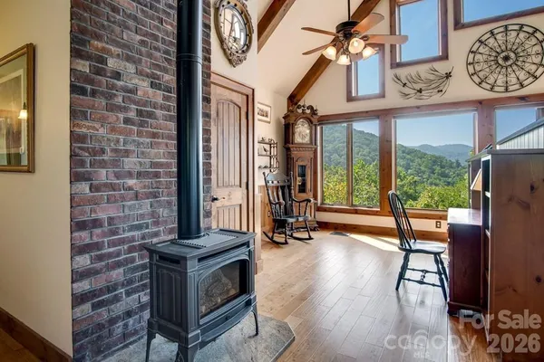 a view of a livingroom with furniture and floor to ceiling window