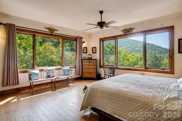 a bedroom with a bed and a large window