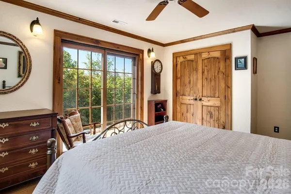 a bedroom with a bed and a large mirror