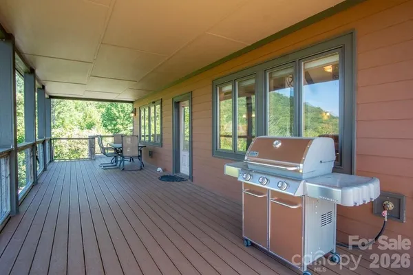 a living room with furniture and large windows