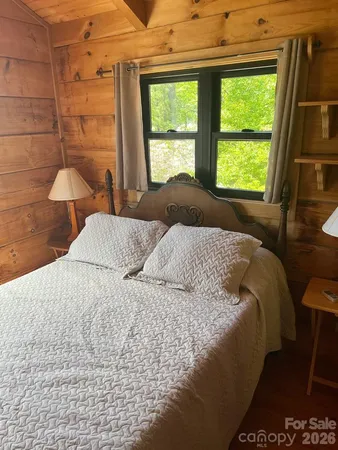 a large bed sitting in a bedroom next to a window