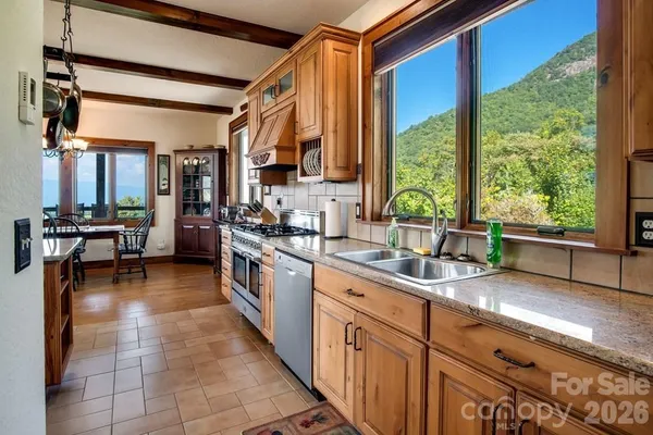 a kitchen with stainless steel appliances granite countertop sink stove and cabinets