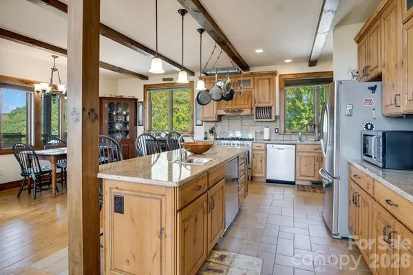 a kitchen with counter top space a sink appliances and cabinets