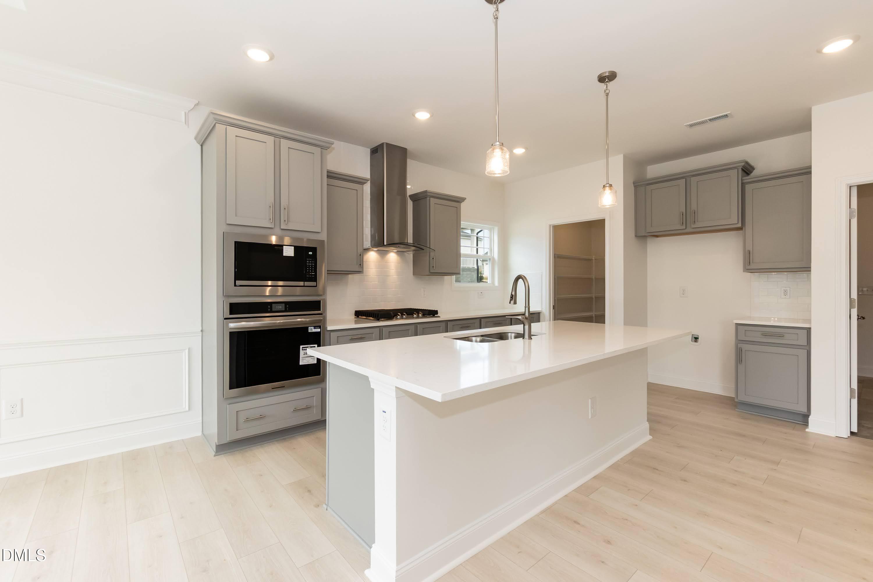 254 Galway Road Lillington, NC 27546 - Photo 11 of 35 a kitchen with stainless steel appliances kitchen island a sink stove and refrigerator
