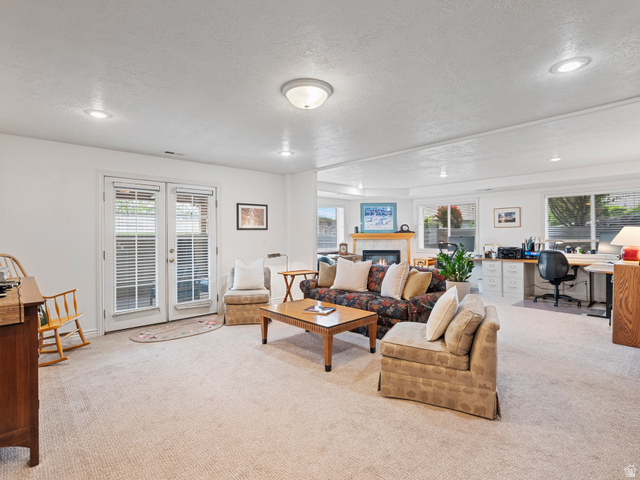 11881 Cottage View Lane Draper, UT 84020 - Photo 14 of 29 Spacious living area featuring light-colored carpeting, recessed lighting, and a prominent fireplace with a wood mantel