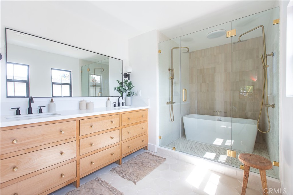 2372 Dewey Street Santa Monica, CA 90405 - Photo 13 of 22 a bathroom with a granite countertop sink a toilet a mirror and shower