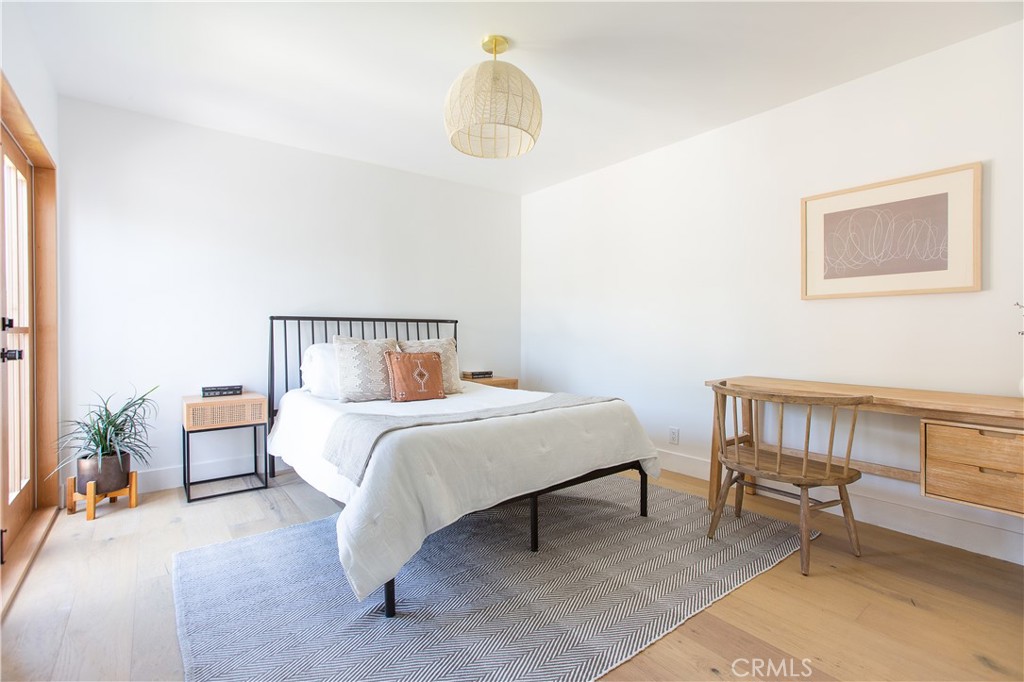 2372 Dewey Street Santa Monica, CA 90405 - Photo 15 of 22 a bedroom with a bed and a chandelier