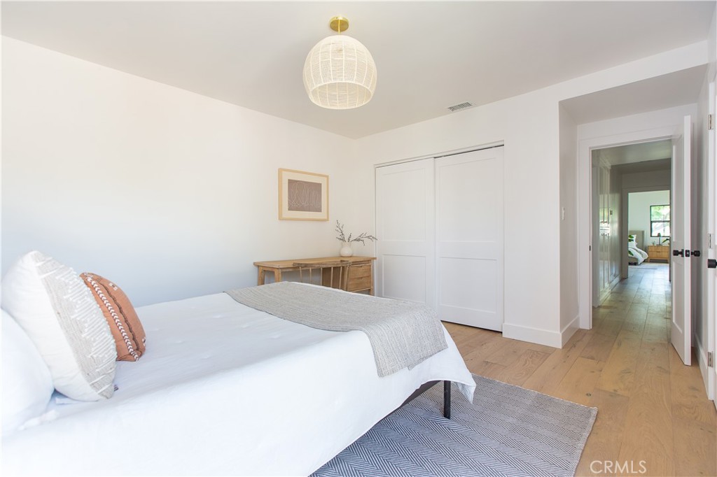 2372 Dewey Street Santa Monica, CA 90405 - Photo 16 of 22 a bedroom with a bed and a chandelier