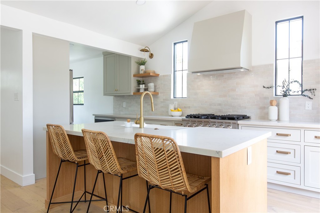 2372 Dewey Street Santa Monica, CA 90405 - Photo 5 of 22 a kitchen with a dining table chairs and a refrigerator