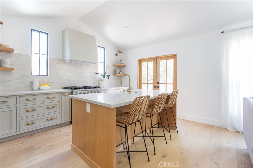 2372 Dewey Street Santa Monica, CA 90405 - Photo 6 of 22 a kitchen with stainless steel appliances kitchen island granite countertop white cabinets and window