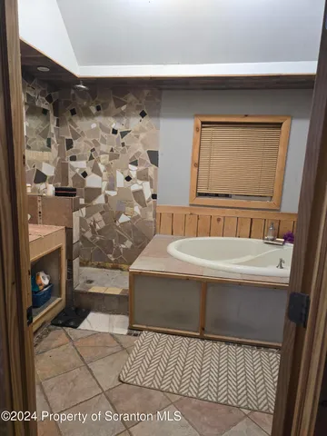 a bathroom with a bathtub and a shower