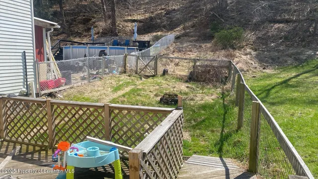 a view of a balcony with floor to ceiling window and wooden fence