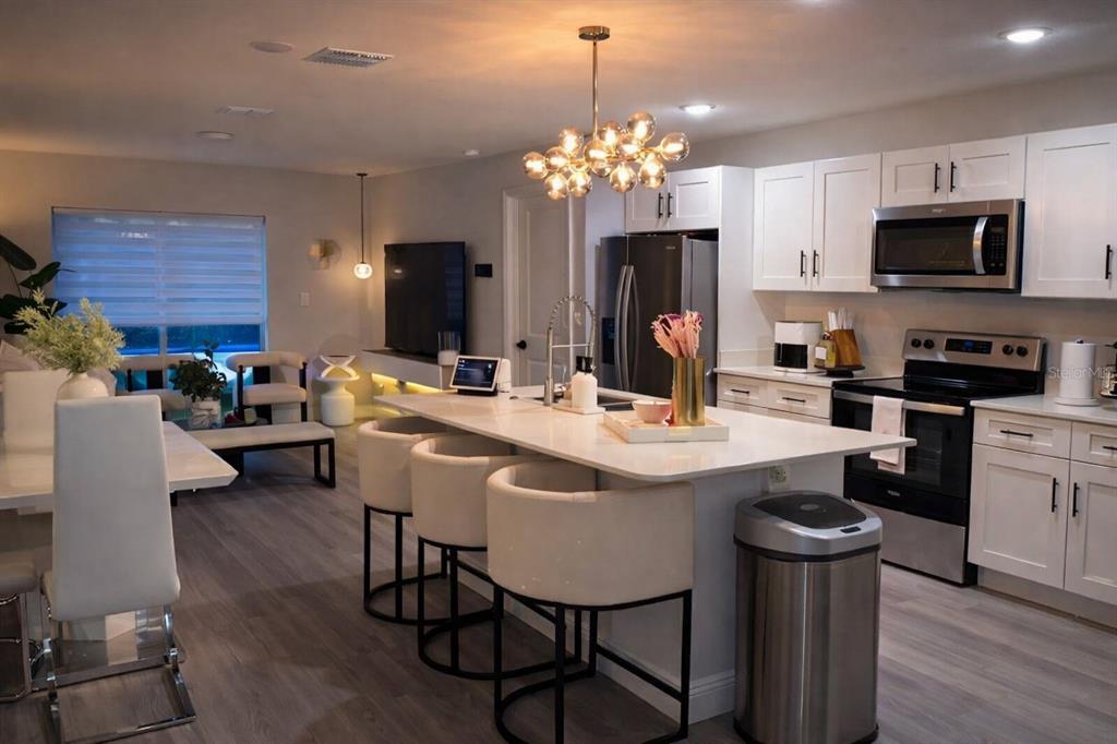 39 Redwood Track Run Ocala, FL 34472 - Photo 2 of 5 a kitchen with sink a refrigerator and chairs