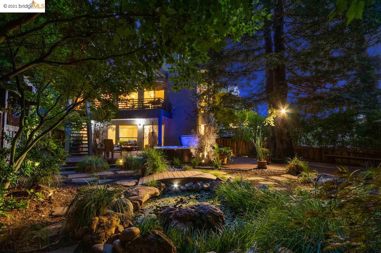 a view of swimming pool with lawn chairs and plants