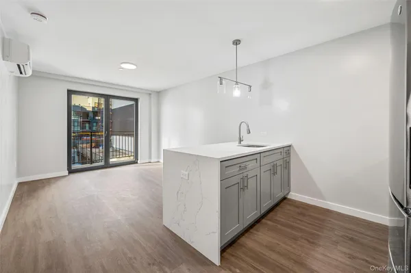 a kitchen with sink cabinets and wooden floor