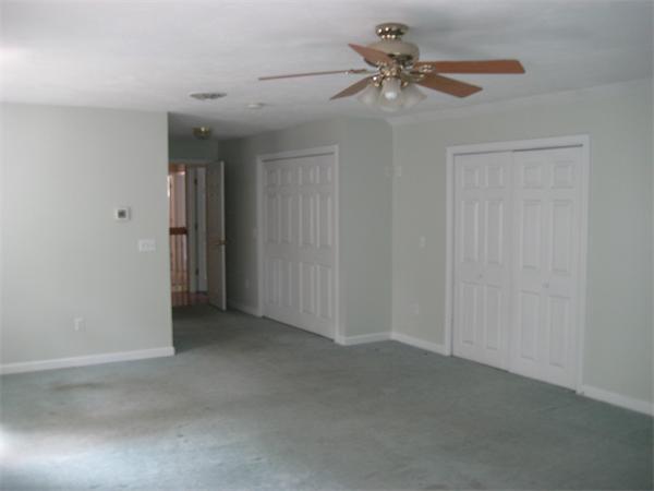 71 Spectacle Hill Road Bolton, MA 01740 - Photo 16 of 20 an empty room with a ceiling fan and a window