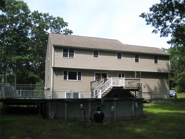 71 Spectacle Hill Road Bolton, MA 01740 - Photo 2 of 20 a front view of house with yard barbeque oven and outdoor seating