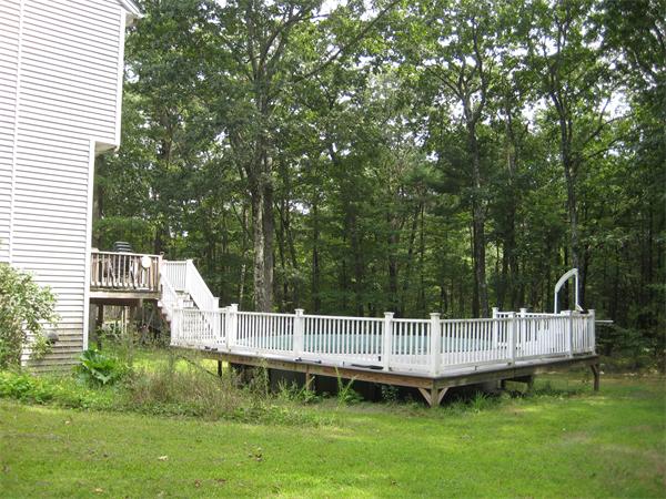 71 Spectacle Hill Road Bolton, MA 01740 - Photo 3 of 20 a view of a house with a yard deck and a small yard