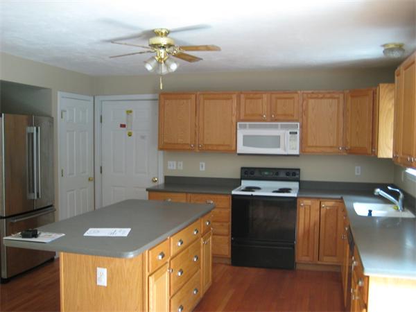 71 Spectacle Hill Road Bolton, MA 01740 - Photo 6 of 20 a kitchen with stainless steel appliances granite countertop a sink stove and refrigerator