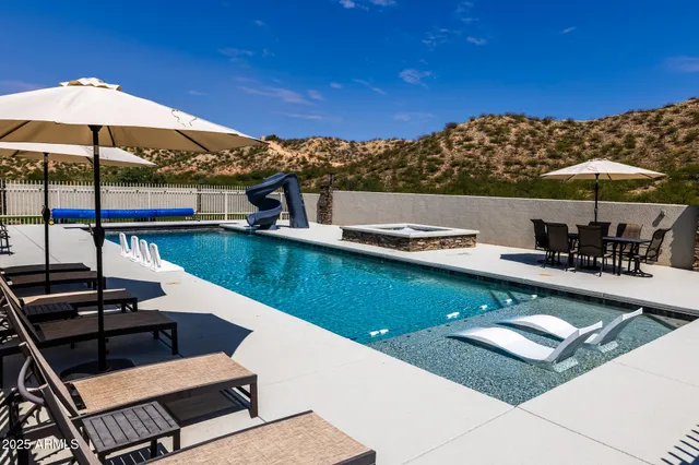 a view of a house with sitting area and a lake view