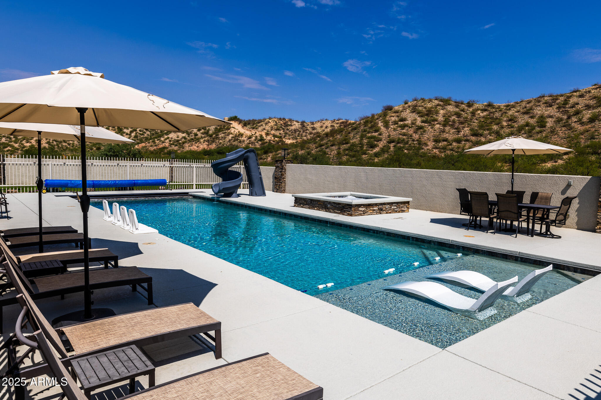 1778 East Ramsey Road Benson, AZ 85602 - Photo 38 of 50 a view of a swimming pool with chairs in patio