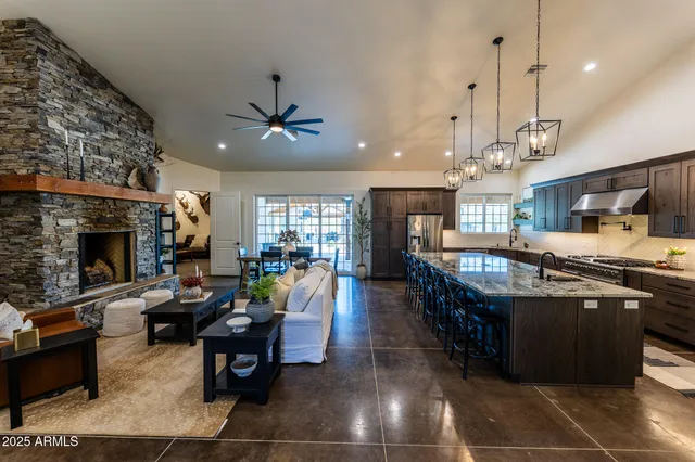 a living room with furniture a fireplace and a chandelier