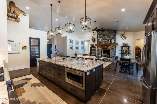 a large kitchen with stainless steel appliances granite countertop a stove oven and a refrigerator