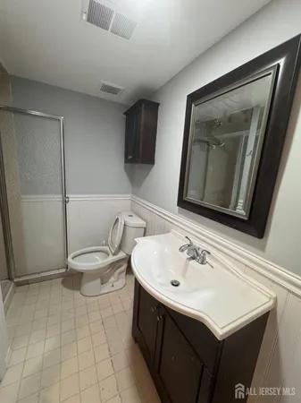 a bathroom with a sink toilet and mirror