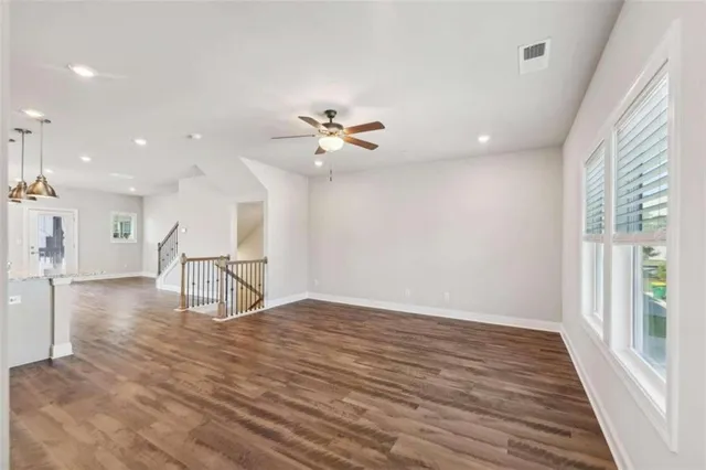 a view of a livingroom with a hardwood floor and a ceiling fan