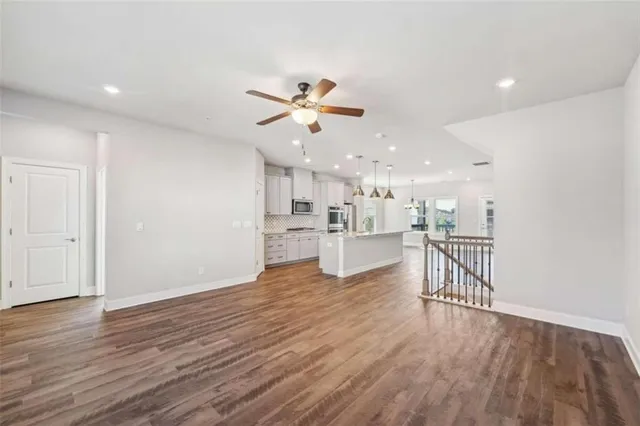 a view of kitchen with wooden floor and a refrigerator