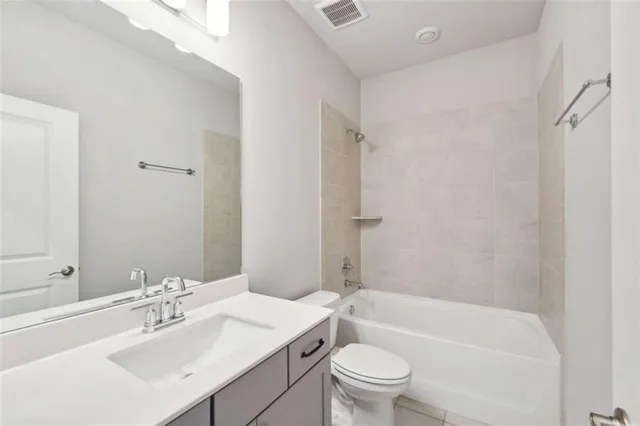 a bathroom with a sink toilet vanity and shower