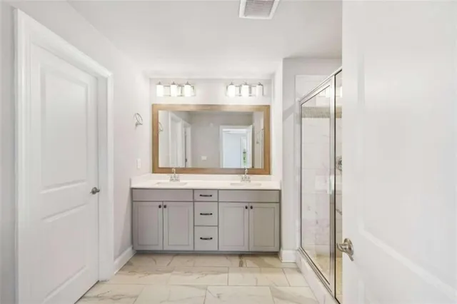 a spacious bathroom with a mirror a sink and a mirror
