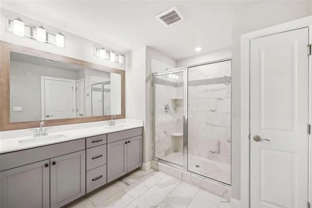 a bathroom with a shower sink and mirror