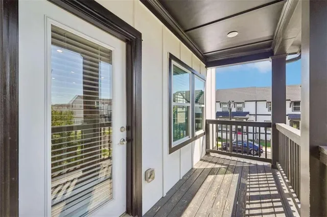 a view of a balcony with wooden floor