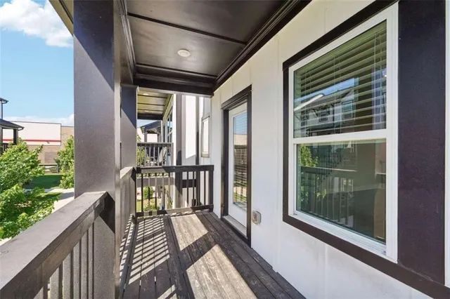 a view of a balcony with wooden floor