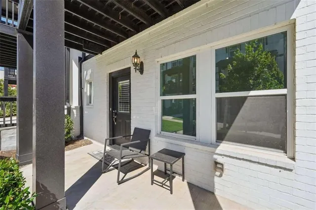 a balcony with furniture and a potted plant