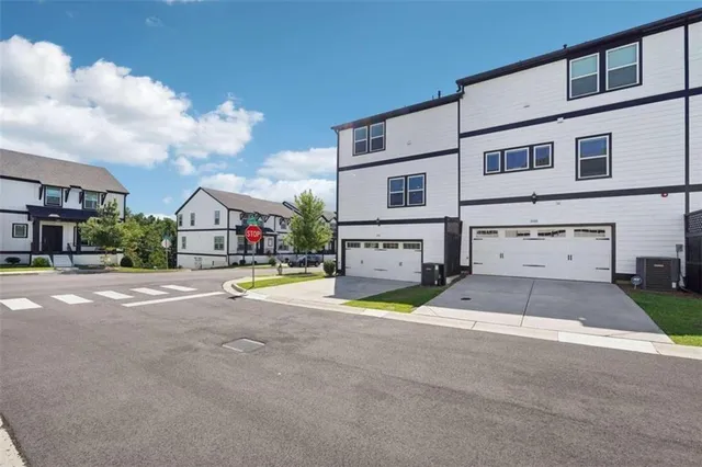 a view of pool with umbrella and wooden fence