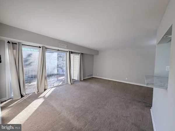 a view of an empty room with glass door