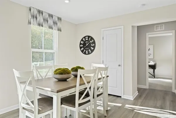 a view of a dining room with furniture and wooden floor