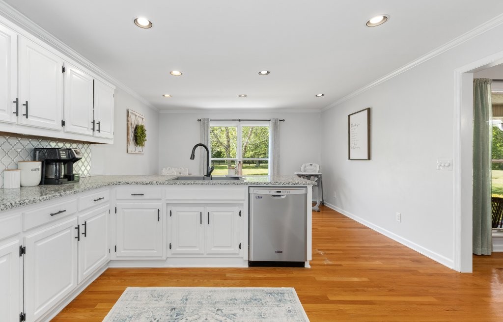 3597 McMahan Road Morrison, TN 37357 - Photo 12 of 45 a kitchen with granite countertop wooden cabinets a sink and dishwasher