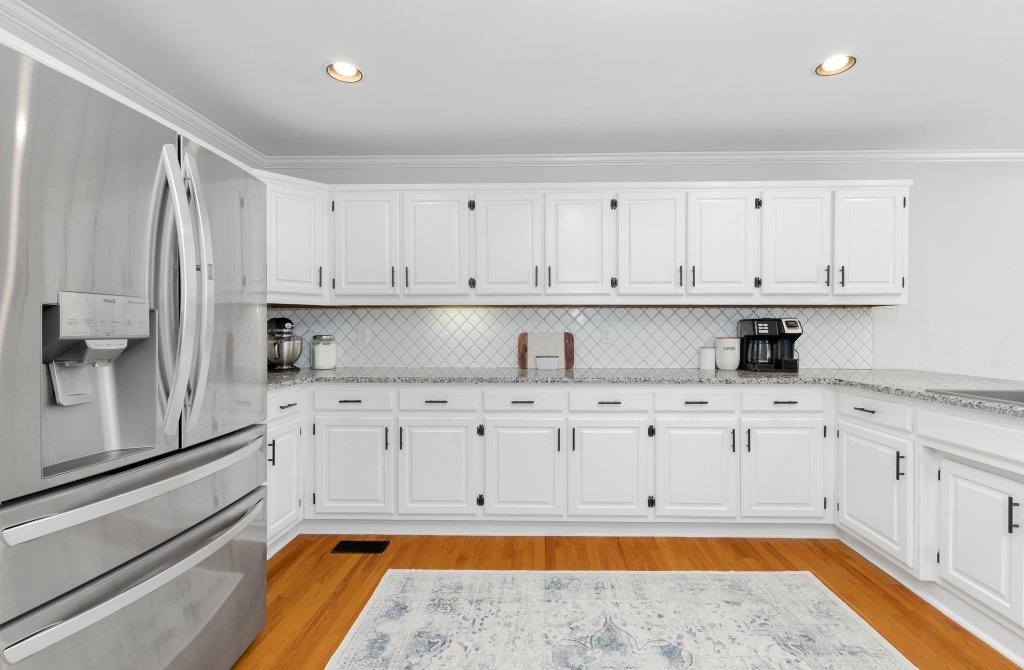 3597 McMahan Road Morrison, TN 37357 - Photo 14 of 45 a kitchen with granite countertop white cabinets stainless steel appliances a sink and wooden floor