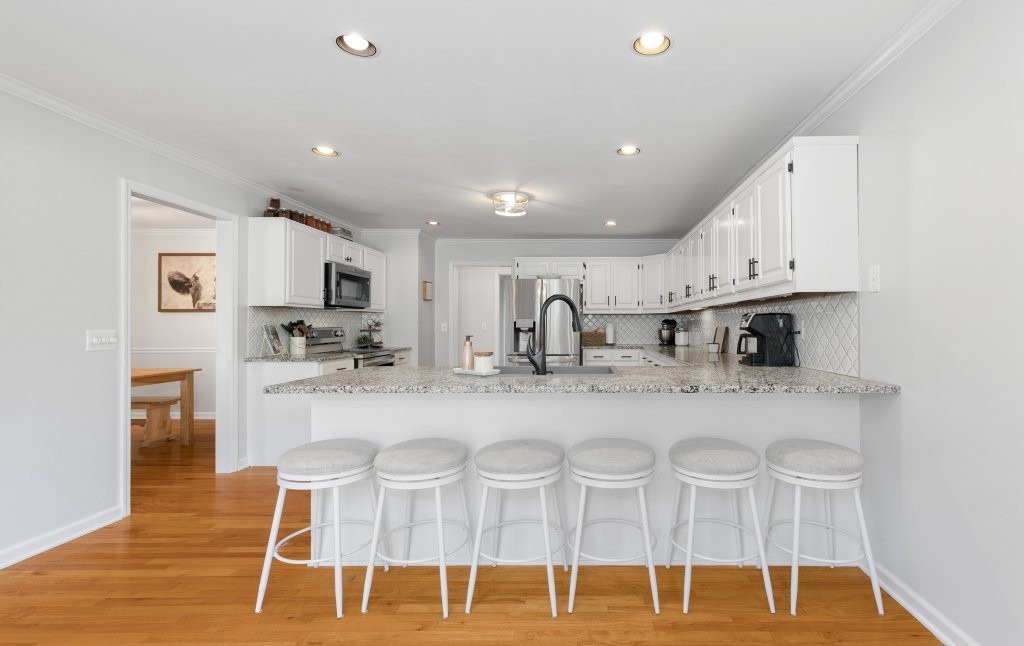 3597 McMahan Road Morrison, TN 37357 - Photo 17 of 45 a kitchen with stainless steel appliances kitchen island granite countertop a dining table chairs sink and cabinets