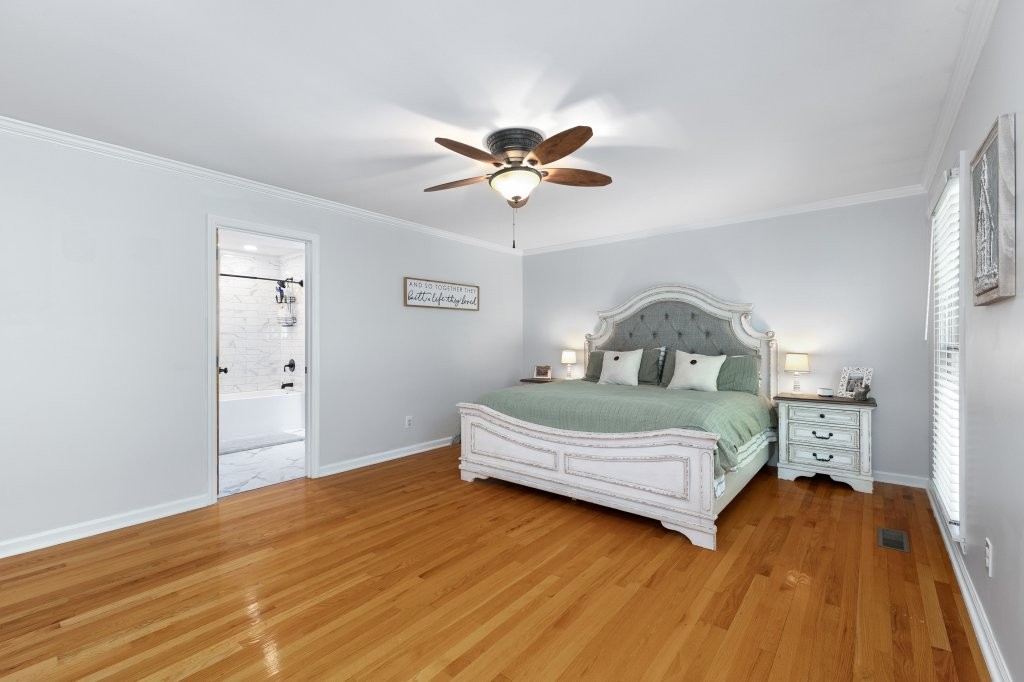 3597 McMahan Road Morrison, TN 37357 - Photo 25 of 45 a bedroom with a bed and a chandelier