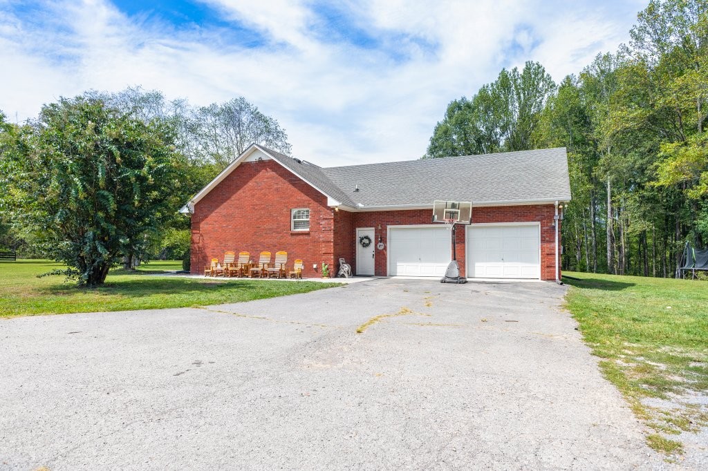 3597 McMahan Road Morrison, TN 37357 - Photo 3 of 45 a front view of a house with a yard and garage