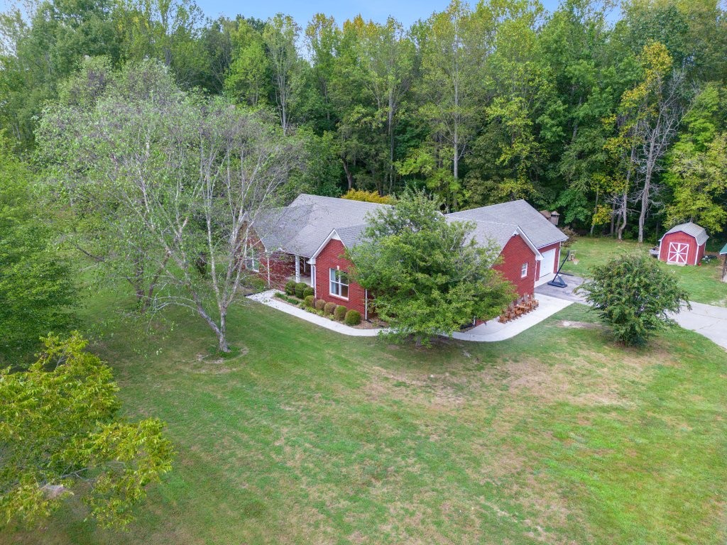 3597 McMahan Road Morrison, TN 37357 - Photo 35 of 45 a backyard of a house with lots of green space and trees