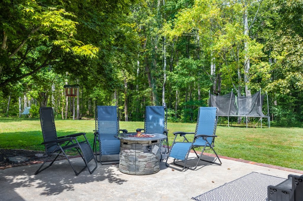 3597 McMahan Road Morrison, TN 37357 - Photo 44 of 45 a view of a sitting area with a table and chairs under an umbrella
