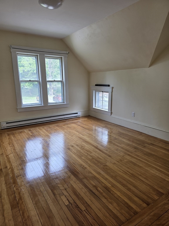 48 Maple Street, Unit 2 Holden, MA 01520 - Photo 6 of 11 an empty room with wooden floor and windows