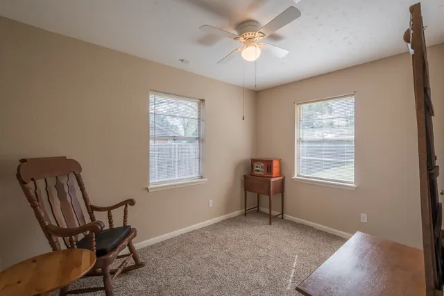 a view of room with workspace and windows