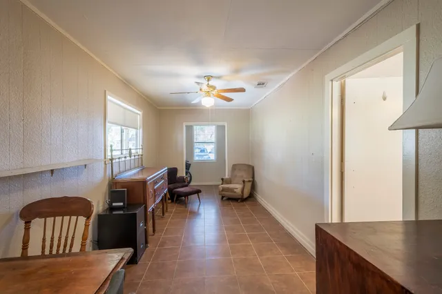 a living room with furniture two window and a table