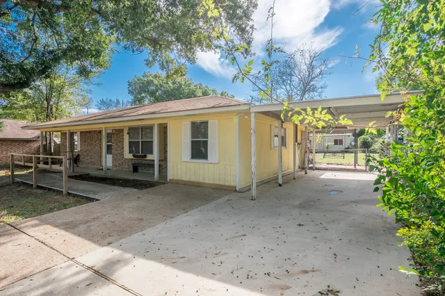 a view of a house with a tree in the background